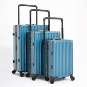 Set of blue suitcases of different sizes on a white background