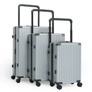 Set of silver suitcases with black handles and wheels on a white background