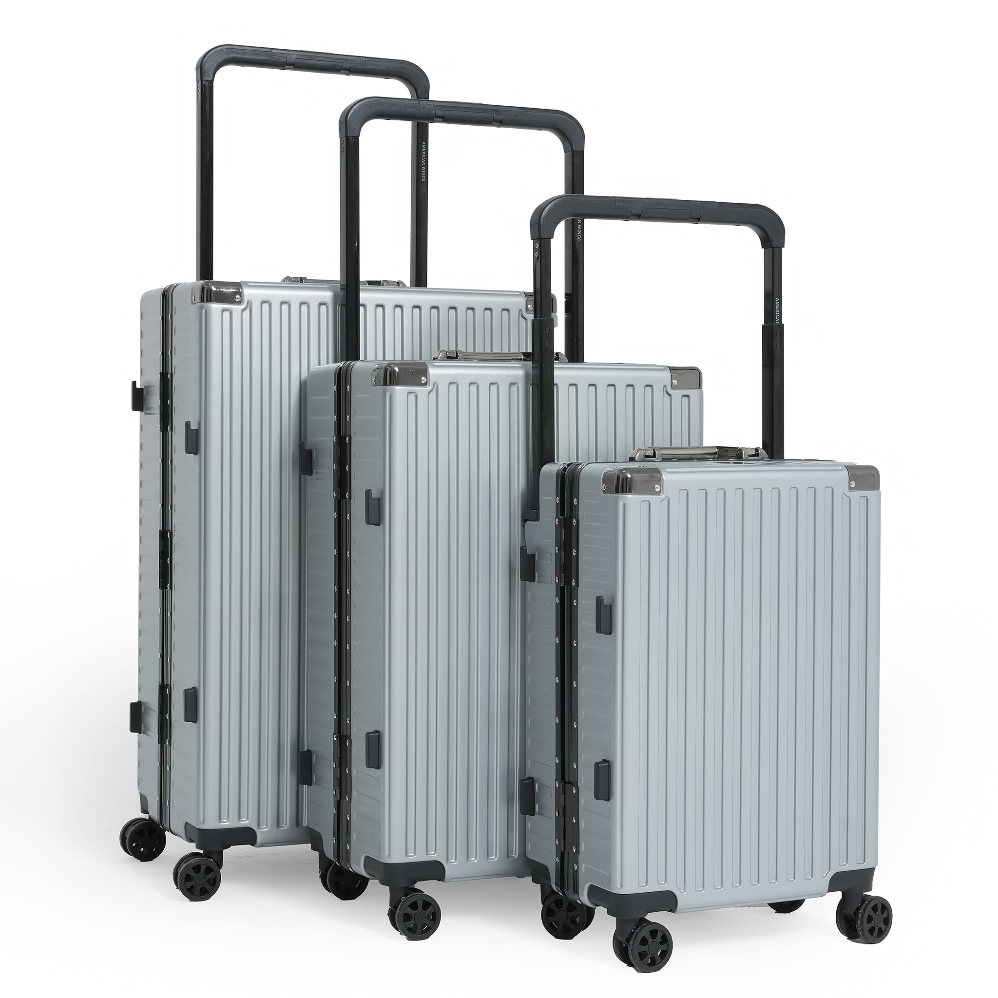 Set of silver suitcases with black handles and wheels on a white background