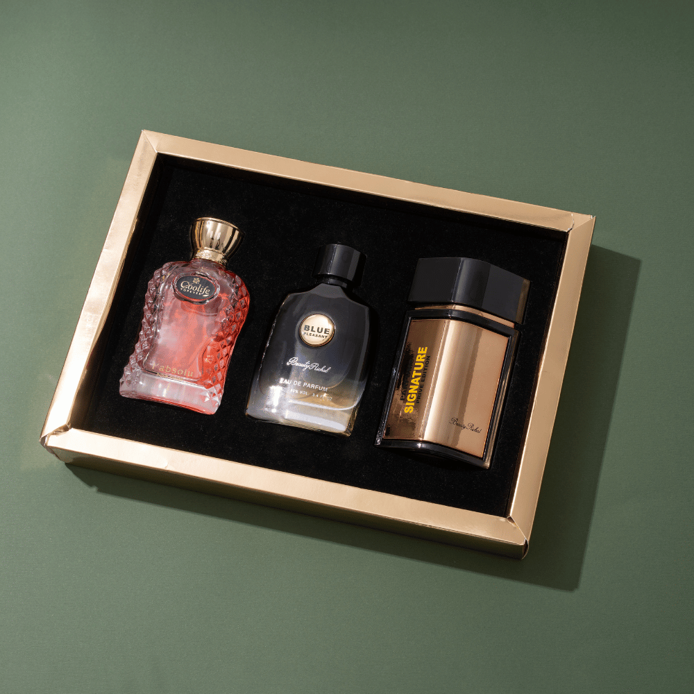 Three bottles in a decorative box on a green background