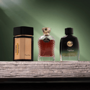Three perfume bottles on a wooden surface with a green gradient background