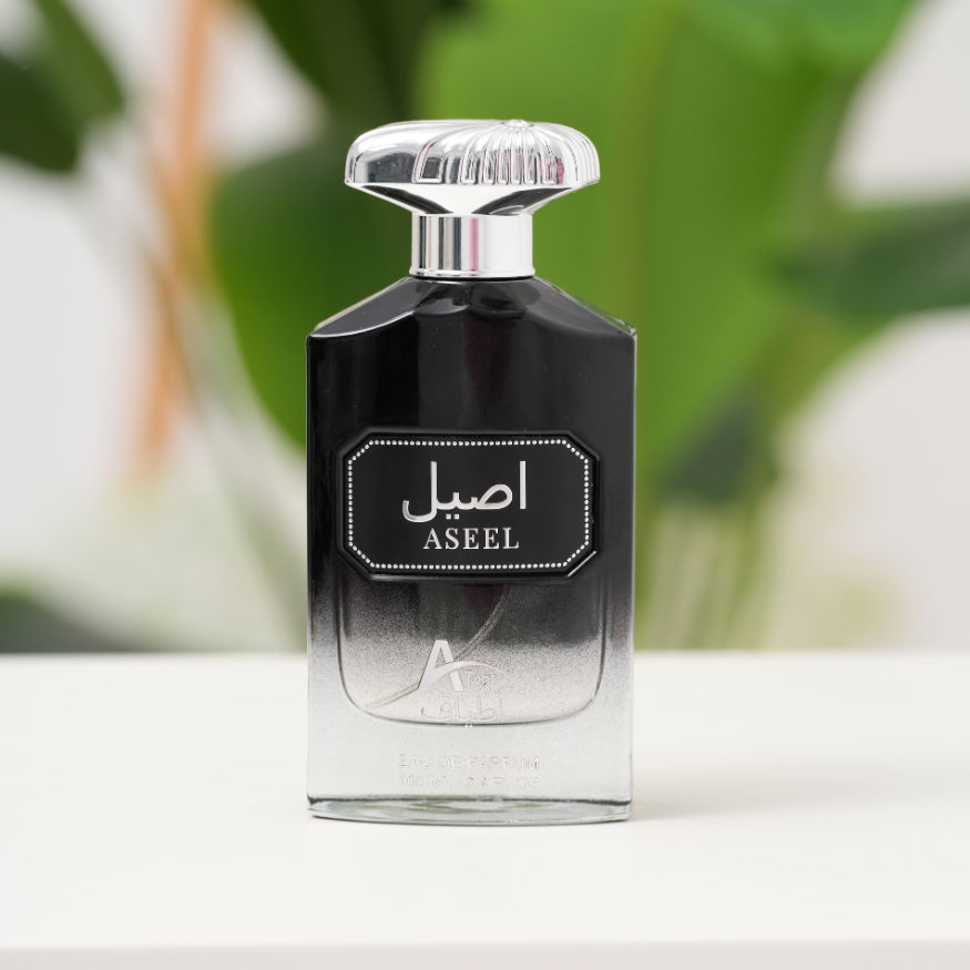 Perfume bottle labeled 'Aseel' with a blurred green background