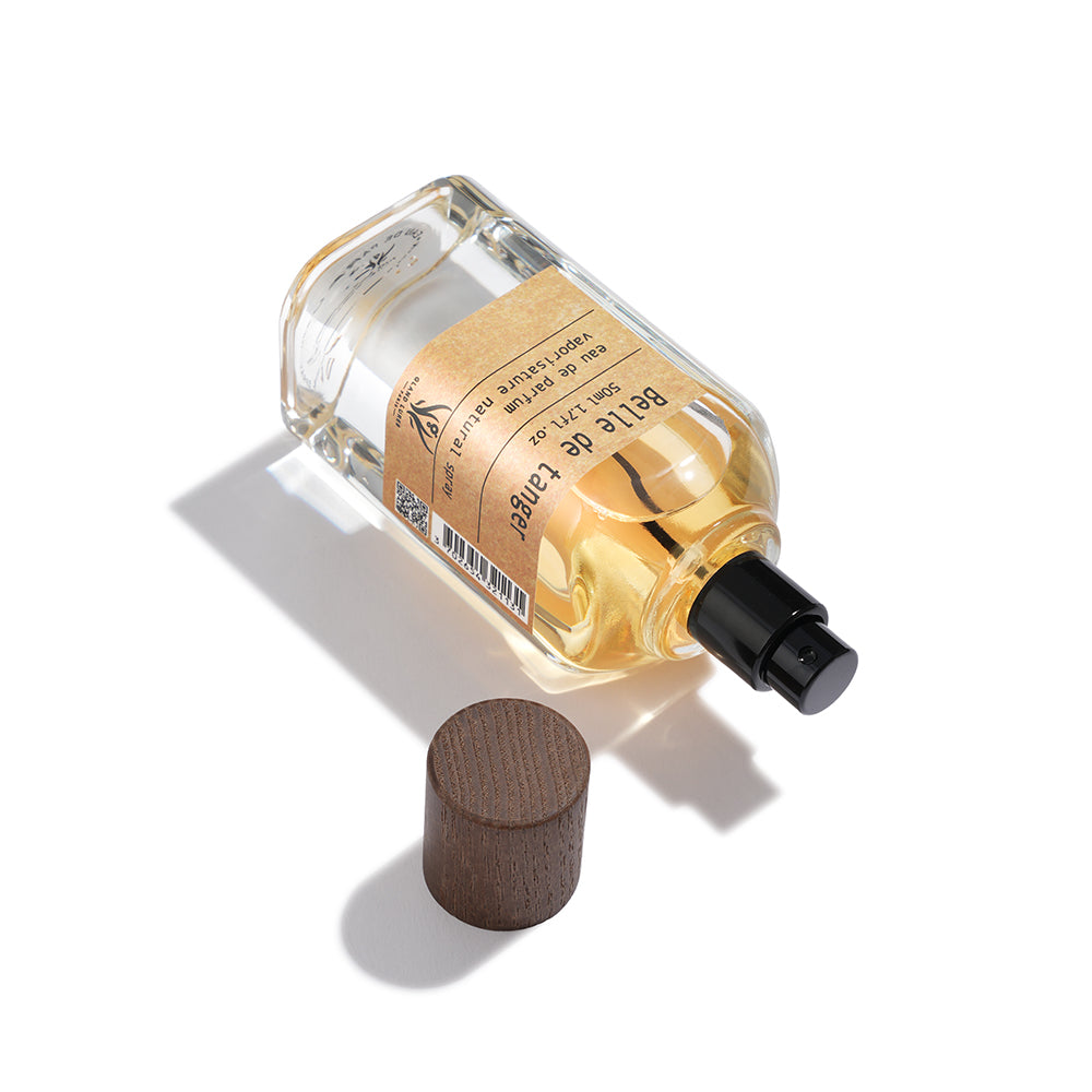 Perfume bottle with wooden cap on a white background