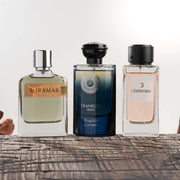 Three perfume bottles labeled 'Miramar', 'Franklin Irish', and 'L'empereur' on a wooden surface.