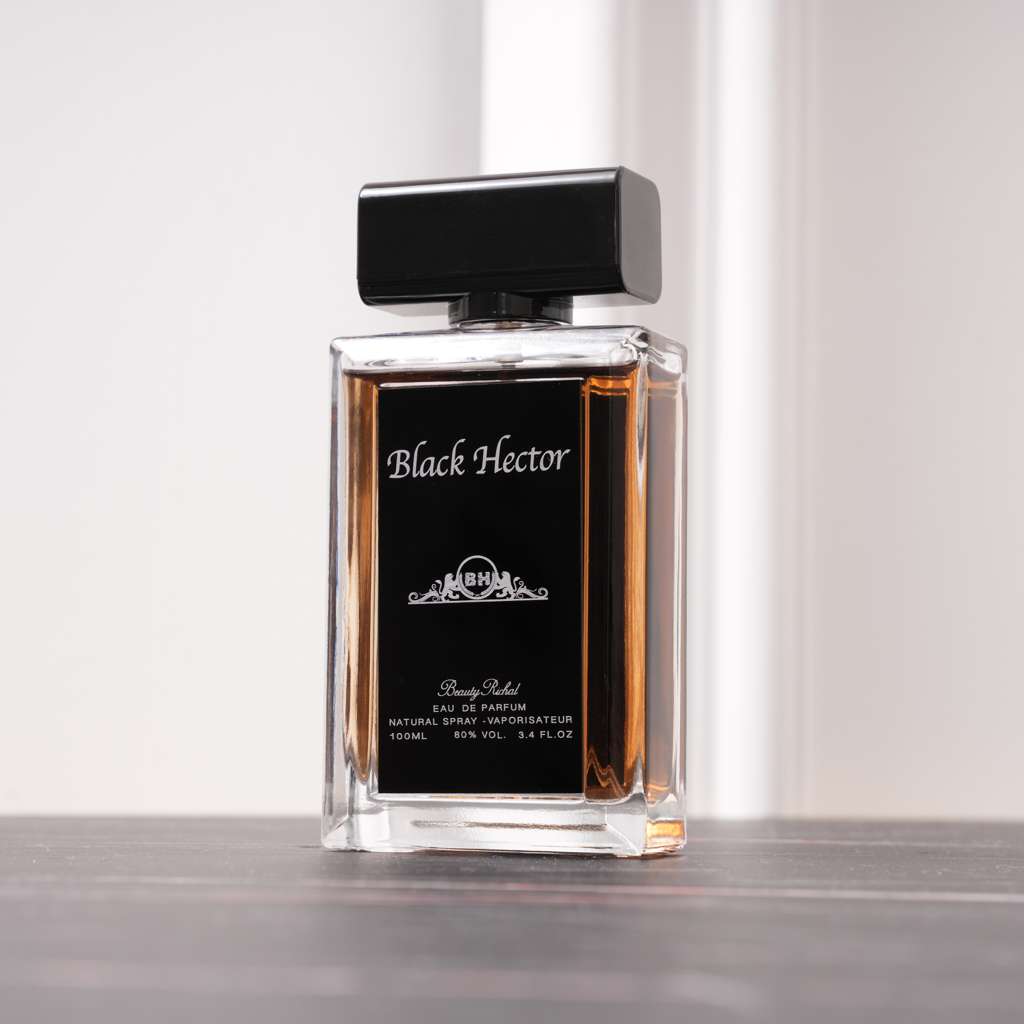 Perfume bottle labeled 'Black Hector' on a reflective surface with a light gray background