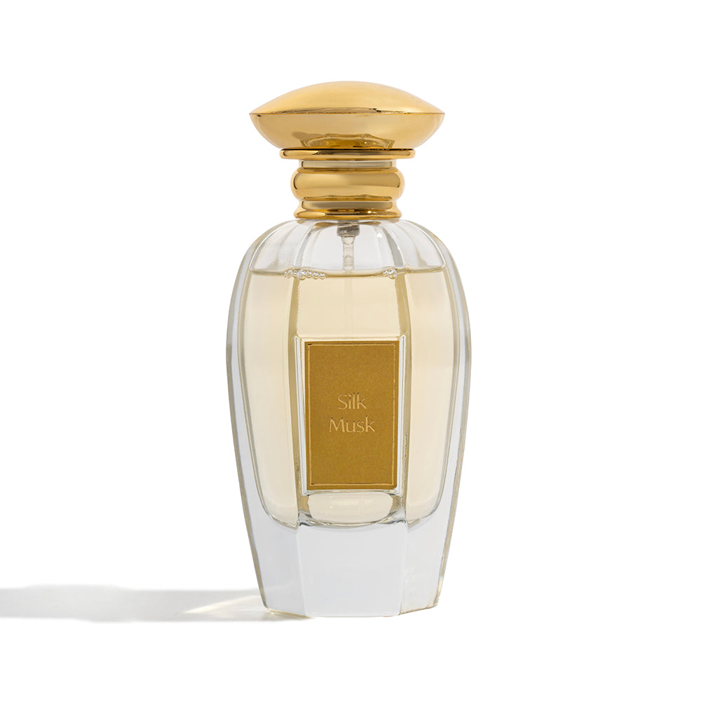 Perfume bottle labeled 'Silk Musk' with a gold cap on a white background