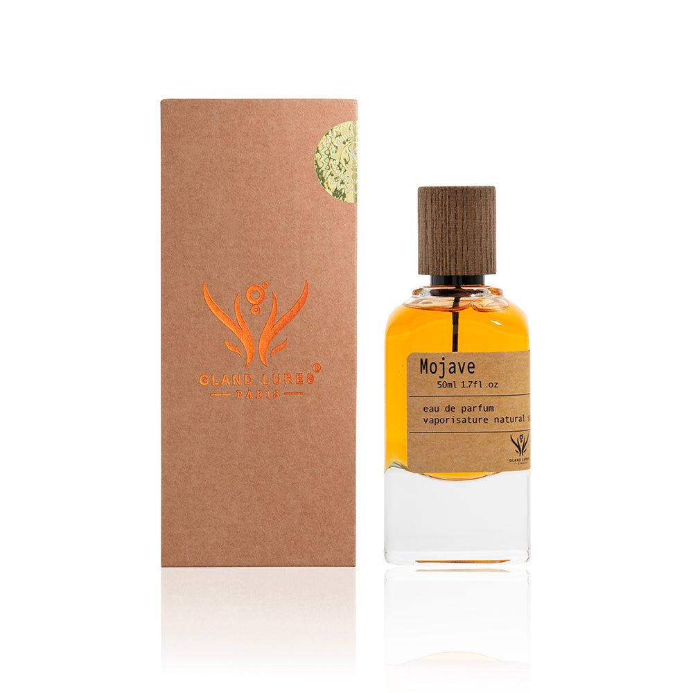 Perfume bottle with wooden cap and 'Clan of Crows' packaging on a white background