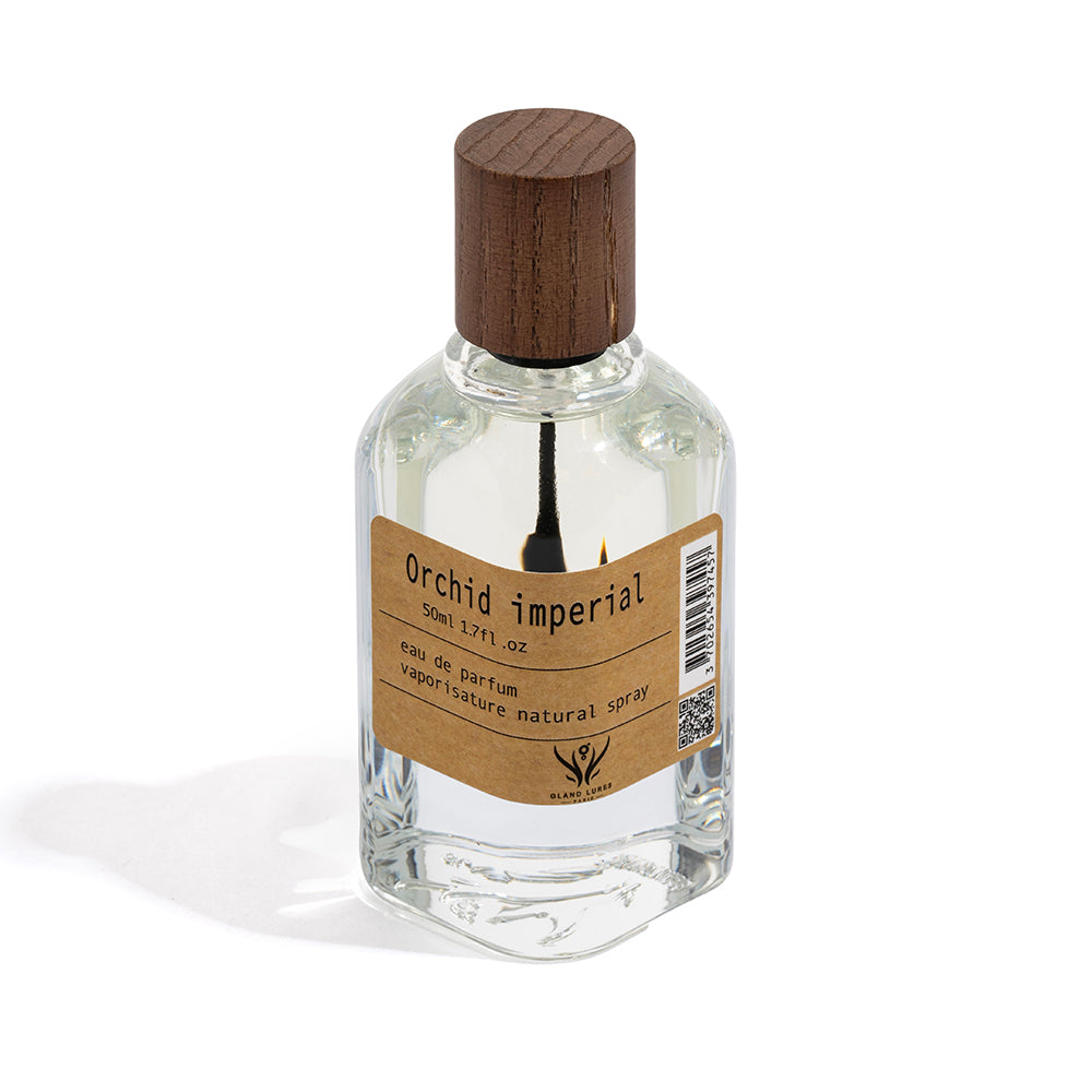 Perfume bottle labeled 'Orchid imperial' with a wooden cap on a white background