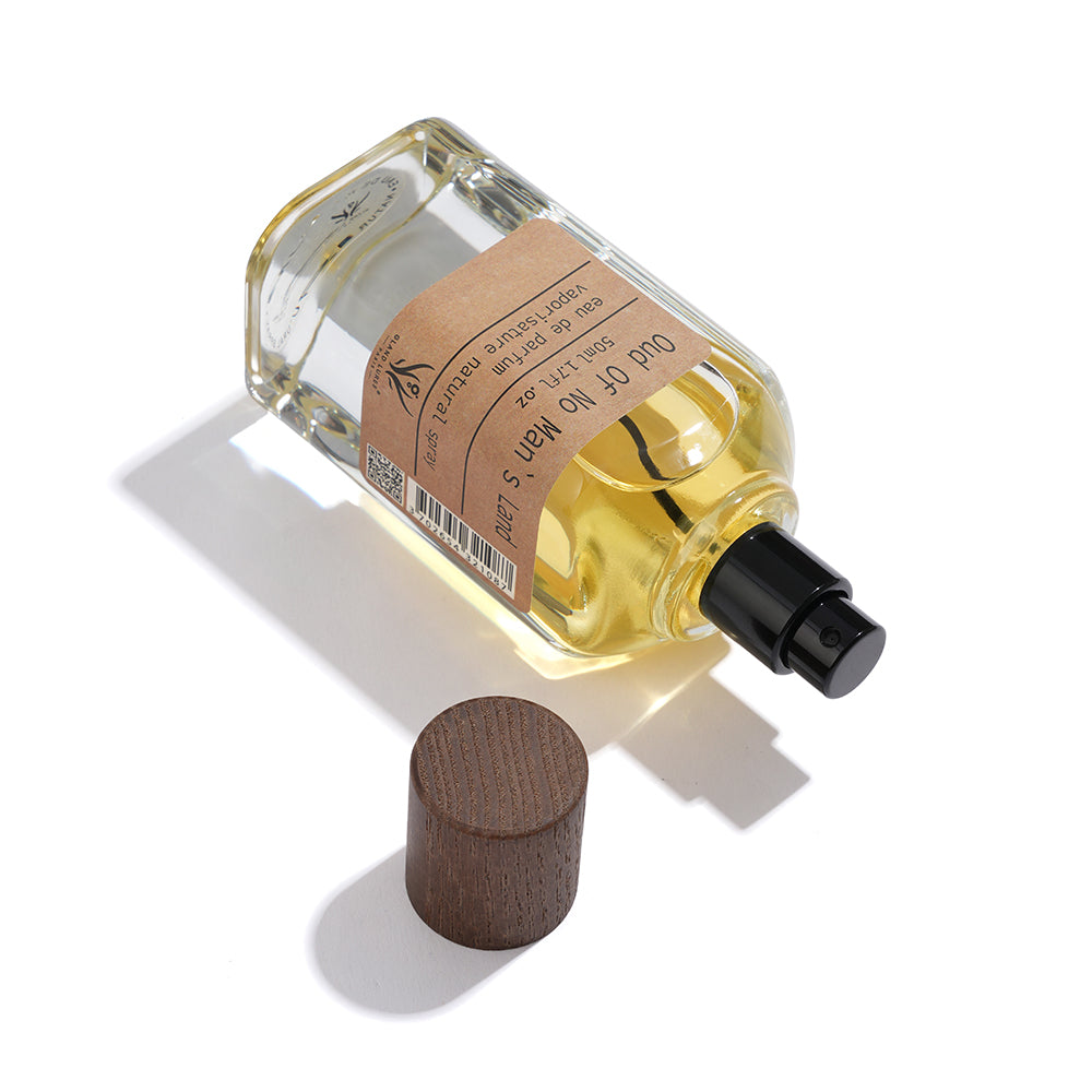 Perfume bottle with wooden cap on a white background