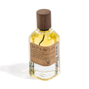 Perfume bottle labeled 'Oud Of No Man's Land' with a wooden cap on a white background