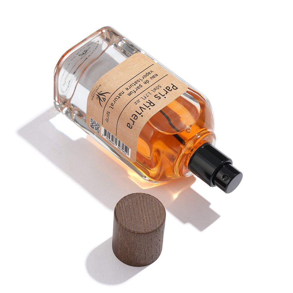 Perfume bottle with wooden cap on a white background