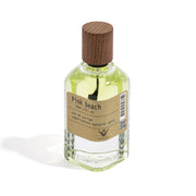 Perfume bottle labeled 'Pink Beach' with a wooden cap on a white background