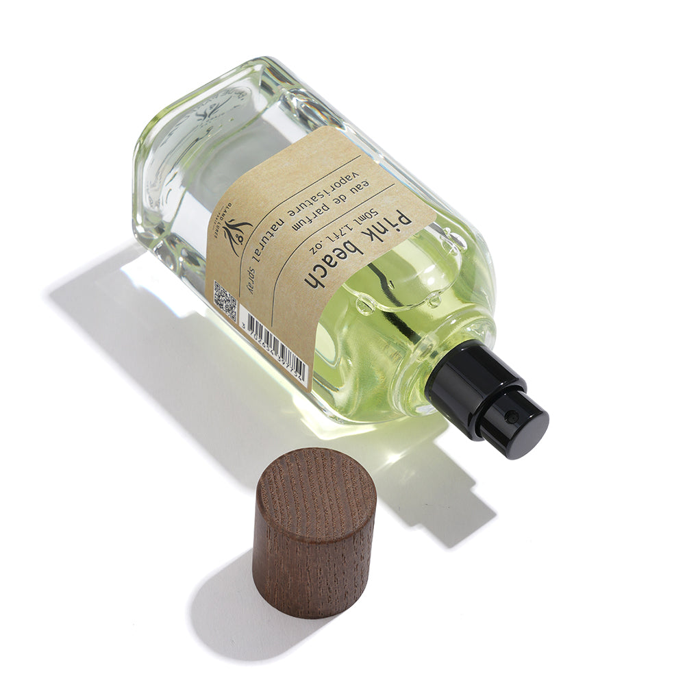 Perfume bottle with wooden cap on a white background