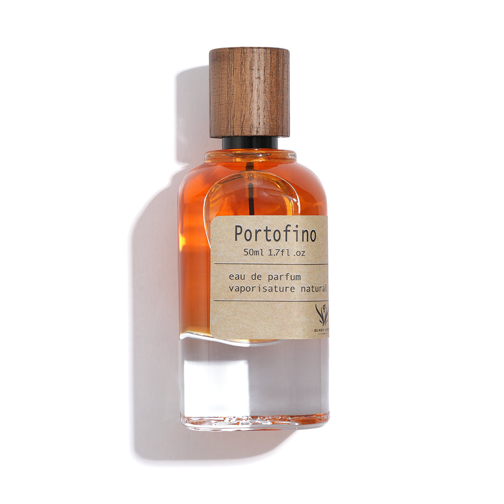 Perfume bottle labeled 'Portofino' with wooden cap on a white background