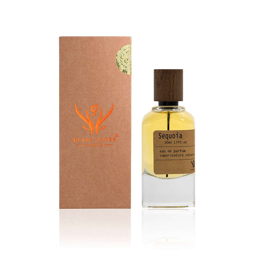 Perfume bottle with wooden cap and packaging on a white background