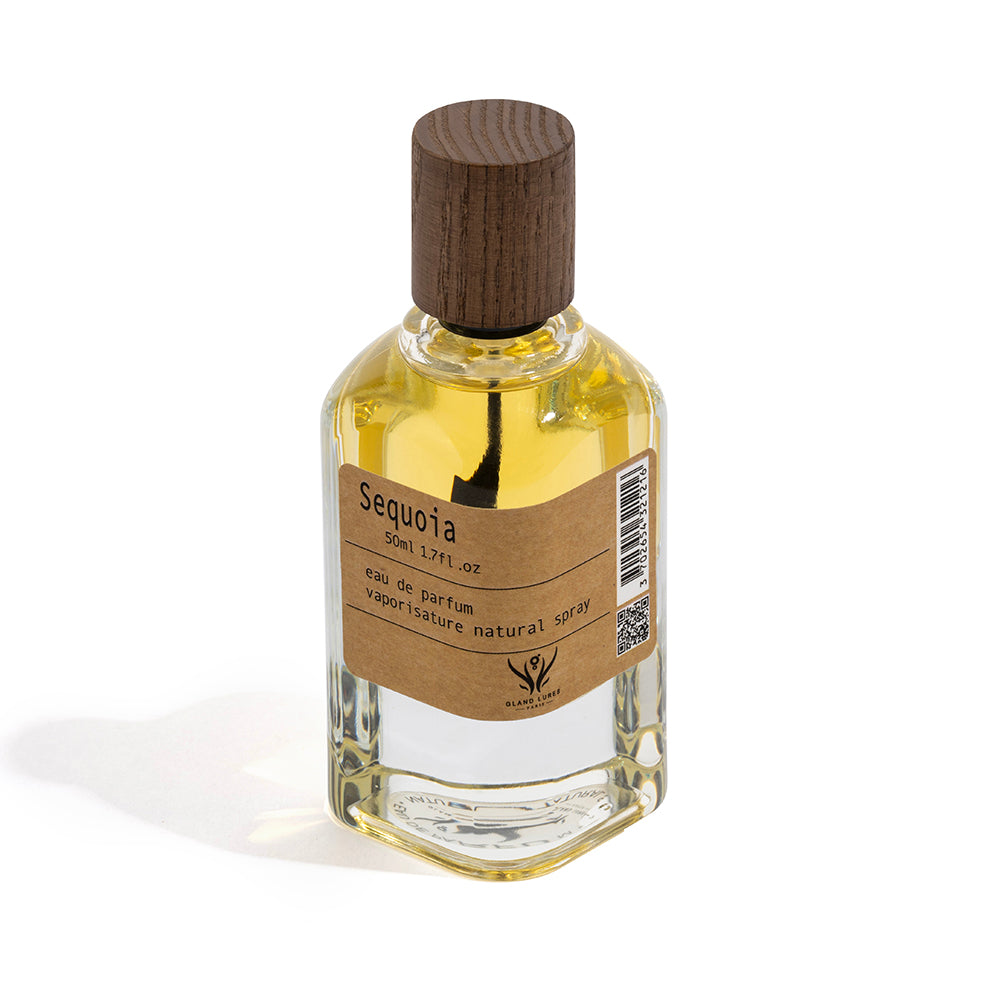 Perfume bottle labeled 'Sequoia' with a wooden cap on a white background