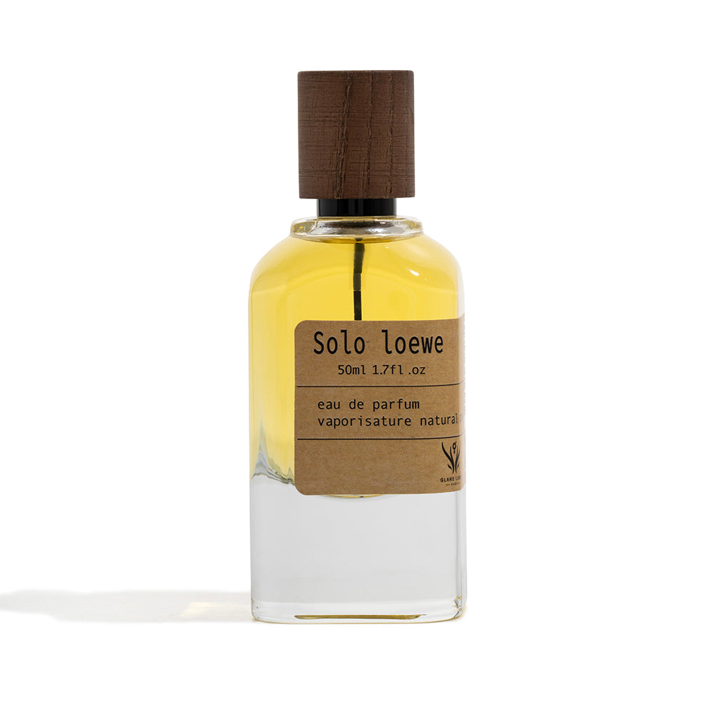 Perfume bottle with wooden cap and 'Solo loewe' label on a white background